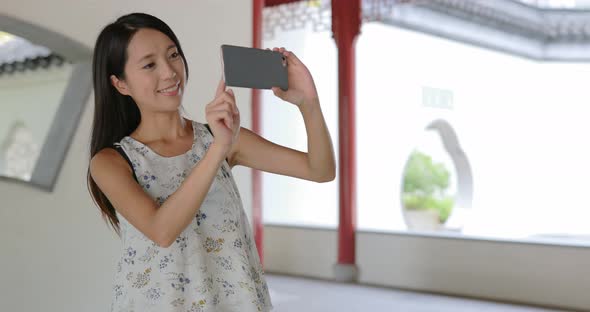 Woman taking photo in chinese garden