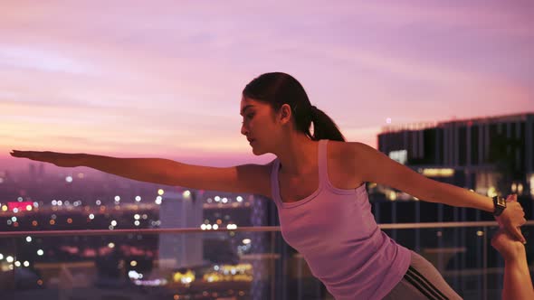 View of Young asian Woman Sitting on Mat and Practicing Yoga and Meditation