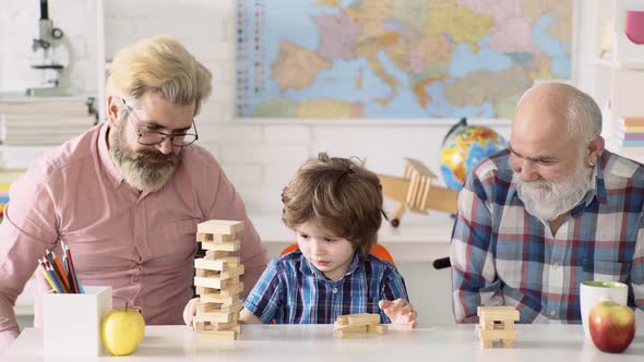 Grandfather Father and Son, Happy Family Playing Board Game at Home, Happiness Childhood Concept