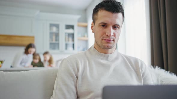 Close Up Portrait of Positive Man Working on Laptop at Home Enjoying Time with Family Fast Motion