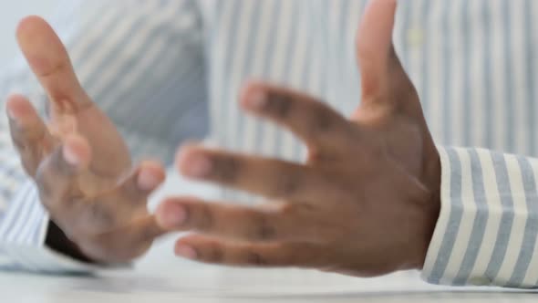 Close Up of African Man Writing on Paper with Pen