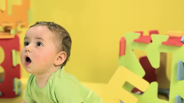 Baby boy playing with toy alphabet letters