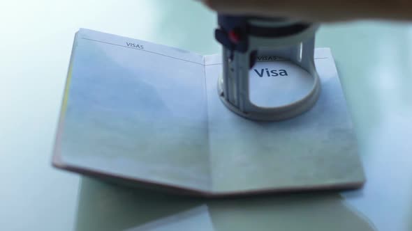 Visa Granted, Customs Officer Hand Stamping Seal in Passport, Travelling Abroad