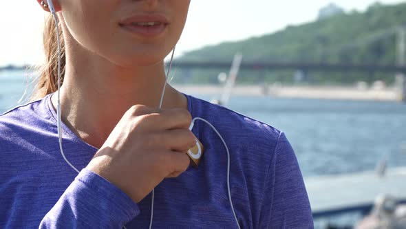 Woman Switches on Her Mp3 Player and Enjoys Music