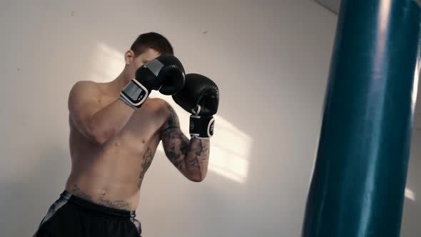 Free Fighter Has Punching Bag in Gym