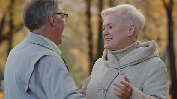 Joyful Happy Mature Elderly Couple Harmony Family Hug in Autumn Park Carefree Talk Lovely Old