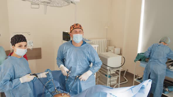 Male Surgeon's Holing the Instrument in Abdomen of Patient