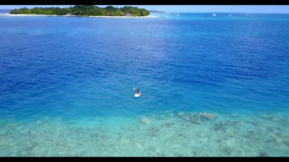 Aerial top down tourism of luxury coast beach adventure by blue water with white sandy background of