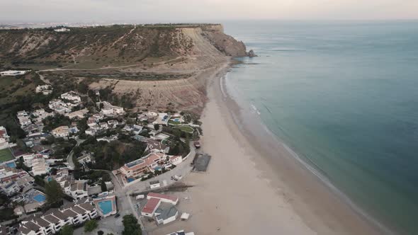 Praia da Luz shore from Rocha Negra headland to beach front. Aerial