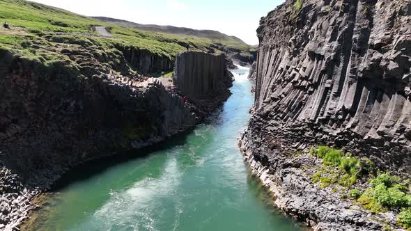 Basalt columns in Studlagil Canyon in East Iceland on sunny day - Drone Shot