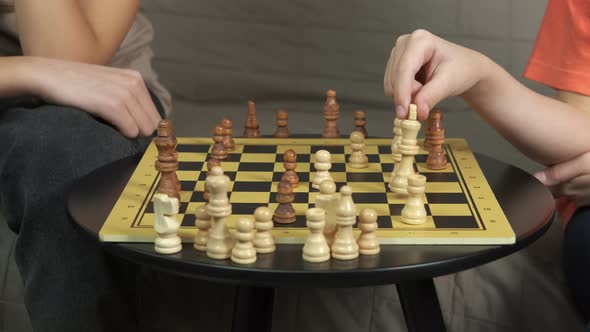 Chess Pieces in Child Hands in Room