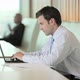 Businessman using laptop and looking at camera - VideoHive Item for Sale