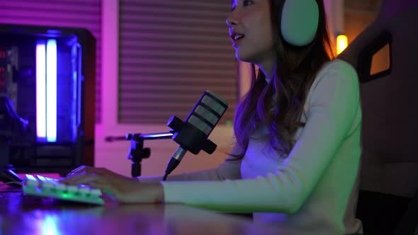 Gamer and E-Sport online of Asian woman playing online computer video game with lighting effect
