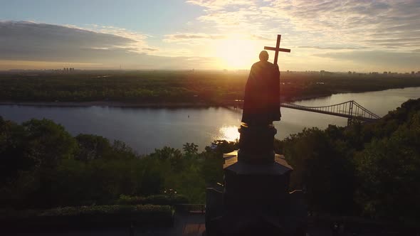 Silhouette Prince Vladimir with Christian Cross in Kiev City on Sunset Landscape