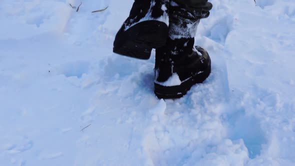 close up of slow motion walking in snow with military boots