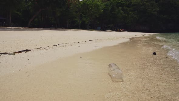 Rubbish on Beach, Single Use Plastic Bottle in Waves on Sandy Shore of White Sand, Garbage Trash and