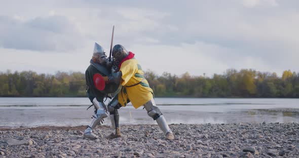 Two armored medieval knights fighting with swords Medieval Europe Crusaders Historical Reenactment
