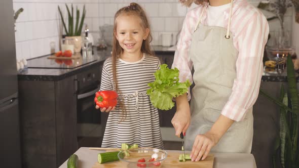 Attentive Mother Kisses Her Cute Daughter Praises Her Helping Out Kitchen Having Fun Cooking Healthy