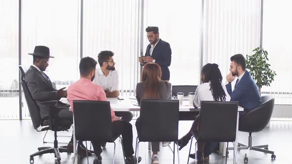 Indian Awesome Man Discussing Company Financial Strategy with His Multirucial Male Managers During