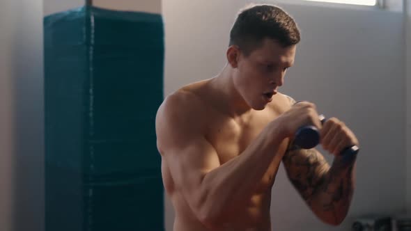 Young Boxer with Tattoos Training in Gym, Slow Motion