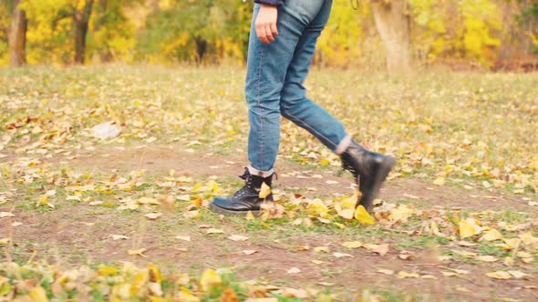 Girl Tourist on a Hike in the Autumn Forest