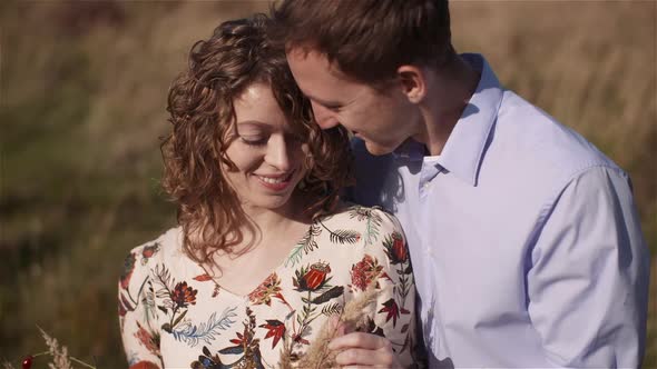 Young Couple Walking on a Meadow