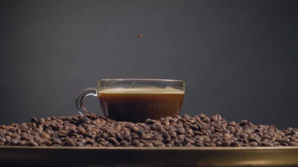 Full Coffee Cup Standing on Pile Grains Close Up