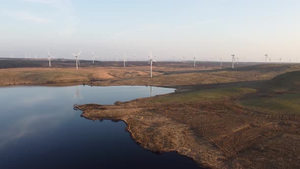 Aerial forward view of wind turbines in remote Scottish location