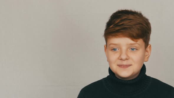 Portrait of a Funny Blond and Blueeyed Teenager Boy Showing Condemnation with Gestures and Facial