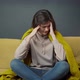 Sick Girl Sits on Sofa Wrapped in Plaid Suffering From Headache or Migraine - VideoHive Item for Sale