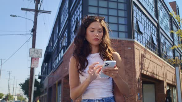 Young Woman Use Smartphone Standing on Crossroad