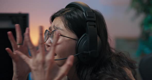 The Face of Woman Wearing Glasses and Headset Upset About Losing Computer Game Broken Gamer Waving