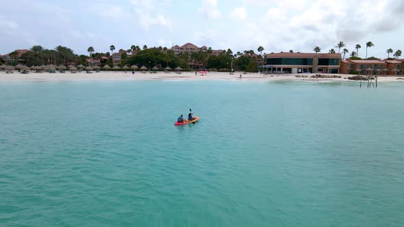 Couple Kayaking in the Ocean on Vacation Aruba Caribbean Sea Man and Woman Mid Age Kayak in Ocean