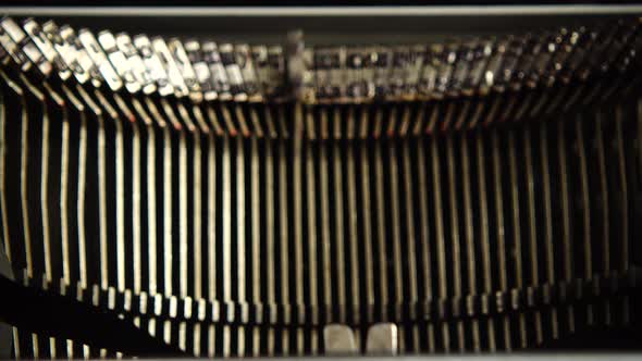 Mechanism of a retro typewriter. Old typewriter hammers. Close up.