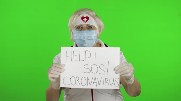 Elderly Female Doctor in Medical Mask Show Page with Message. Coronavirus