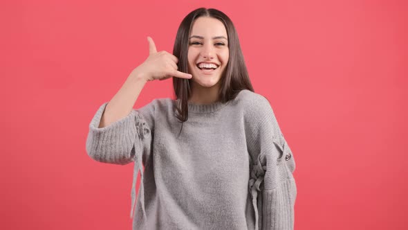 Close Up of a Cute Girl Doing Talking on the Telephone Gesture