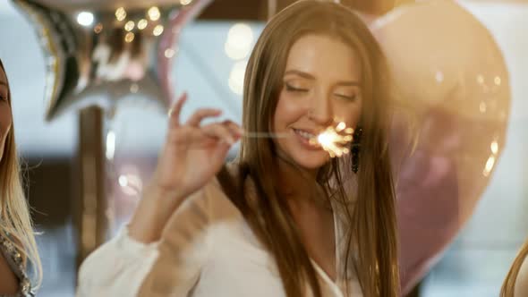 Dreamy Young Woman with Sparkler