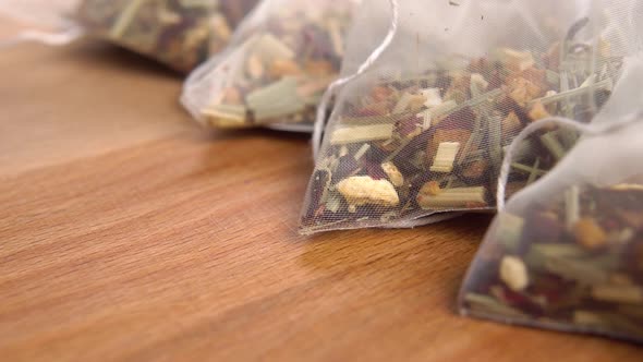 Herbal tea pyramid bag on a wooden surface