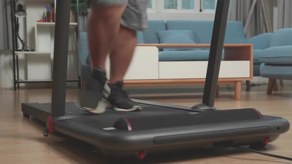 Legs Of Asian Fat Man Running On A Treadmill At Home At Home