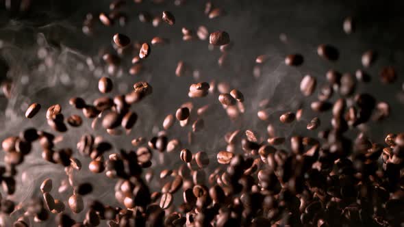 Super Slow Motion Shot of Exploding Premium Coffee Beans and Smoke Isolated on Black at 1000Fps