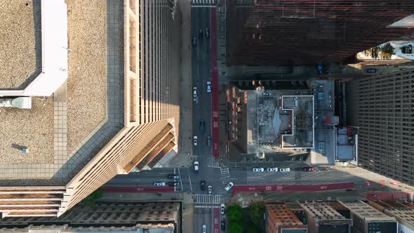 Top down aerial above traffic in downtown urban city in USA. Drone above street in American city. Ro