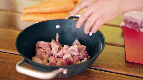 Close-up, Travelling: Young Guy Cooks Pilaf, for a Picnic. He Is in a Summer House, Cuts Meat