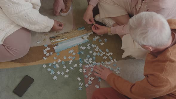 Assembling Puzzle on Floor