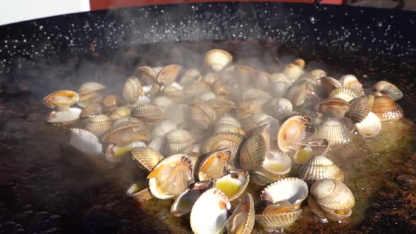 Preparing delicious paella with seafood, typical dish of Valencian cuisine
