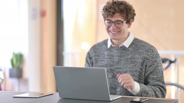 Online Video Chat on Laptop By Young Man at Work 