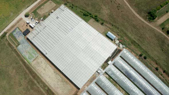 Aerial View Flying Over an Industrial Greenhouse