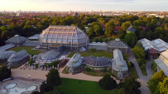 Glass greenhouse Botanical Museum Berlin. Fantastic aerial view panorama curve flight drone footage,