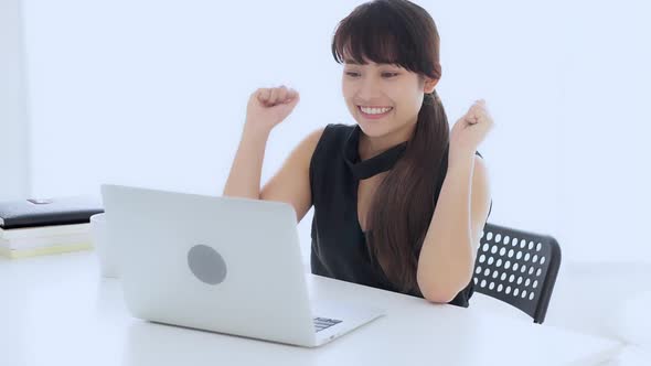 Beautiful freelance young asian woman smile and happy working online laptop computer success.