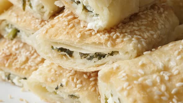 Filo pie with sesame cheese and spinach served on plate 4K 2160p 30fps UHD footage - Serbian  dough 