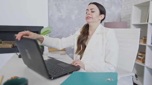 Tired Young Woman Yawning and Closing Laptop Sitting in Office and Falling Asleep at Table